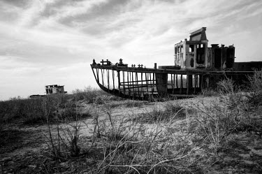 The skeletal remains of an abandoned trawler left to decay on what was once the Aral Sea's shore, now about 40 kms distant. During the 1950s and the 1960s the rivers that feed the Aral Sea (the Amu Da...