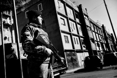 A soldier, holding an semi-automatic rifle, on patrol in the Vele di Scampia (Sails of Scampia), a housing complex (by architect Franz di Salvo) built during the 1960s and early 1970s. Seven separate...