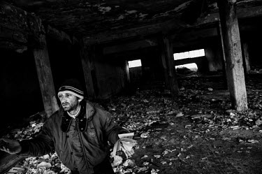 A drug user stands among the injecting paraphernalia in the ground floor of a block in the Vele di Scampia (Sails of Scampia), a housing complex (by architect Franz di Salvo) built during the 1960s an...