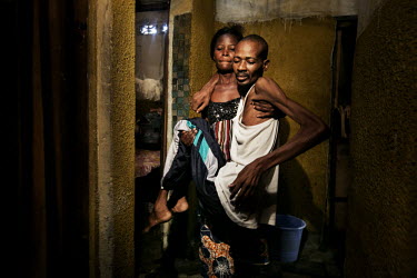 Fuila Batila, in the arms of his wife, has multi resistant TB. He is living in a slum hotel in a room containing just a dirty matrass and mosquito net. The family has no money for his treatment.