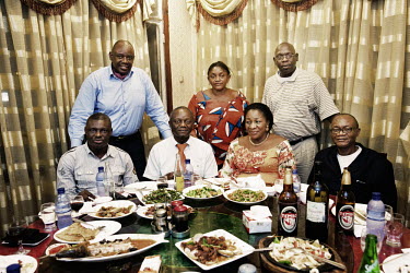 Relatives of football player Vincent Kompany, the captain of Manchester City and the Belgian national team, at a restuararnt in Kinshasa. His father Pierre is seated in the centre.