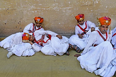Traditional folk dancers rest in between thier day long performances at Mehrangadh Fort during the  Rajasthan International Folk Festival.
