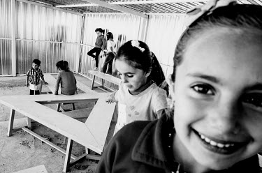Syrian children play during a break at a school in Kawergosk refugee camp in Iraqi Kurdistan. While primary school age children are able to attend class, there are no secondary schools in Kawergosk. T...