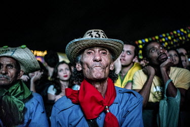 Quadrilha performers watch the final minutes of the Brazil-Cameron football match before performing at a Festa Juninas party around Caruaru, in the northeast of Brazil. The Quadrilha is a typical Braz...