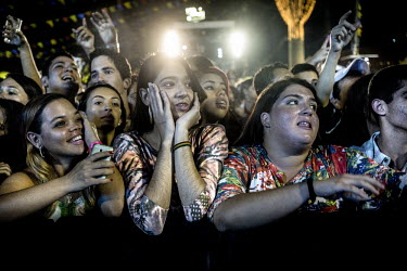 Fans cheer on pop musician Wesley Safadao as he performs at a Festa Junina party in Caruaru, in the Nordeste of Brazil. The Festas Juninas are an annual festival around the saint's days of St. Antony,...