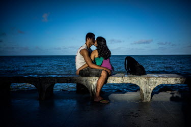 A couple kiss on the sea front in Recife