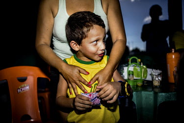 A boy watches the penalty shootout between Brazil and Chile in their World Cup game. Brazil ultimately won it with a score of 3 to 2.