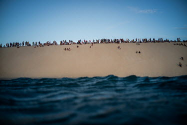 People watch the sunset from the sand dunes in Jericoacoara.