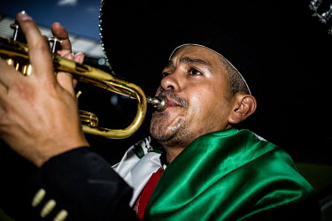 A Mexico fan wearing a sombrero and playing a trumpet at the Mexico vs Netherlands match in Fortaleza. The Netherlands won the game 2:1.