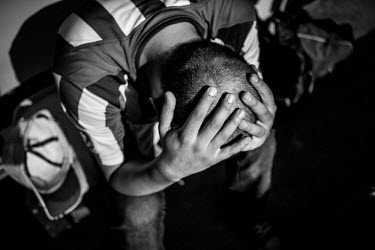 A Mexico fan holds his head in despair after Mexico lost to the Netherlands in the World Cup in Fortaleza.
