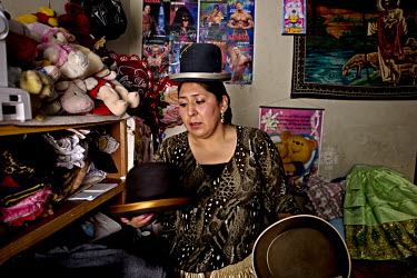 Marta La Altena (aka Jenny Mamani Herrera), a Cholita or wrestler of native Aymara descent, prepares for her Sunday evening bout. When Cholitas fight they wear traditional costume. Here she chooses wh...