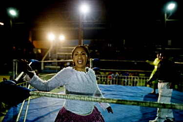 Denita La Intocable, a Cholita (wrestler of native Aymara descent) exhorts her fans to make some noise during her bout with the 'evil' Marta La Altena at the 12 October Stadium in the El Alto district...