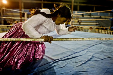 Denita La Intocable (a Cholita or wrestler of native Aymara descent) tries to stagger to her feet during her bout with Marta La Altena. As with All In Wrestling around the world, each wrestler has a g...