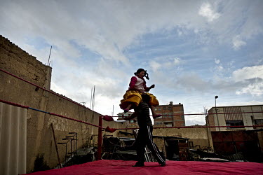Yolanda La Amarosa, a Cholita or wrestler of native Aymara descent, executes the first step in the highly gymnastic 'sesenta y nueve' wrestling move during training session in El Alto.