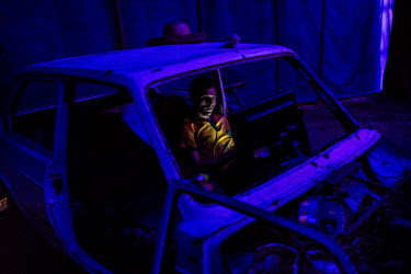 A worker relaxes, sitting in a car wreck and watching television, between acts of the Empyre Family Circus in Fortaleza. The Empyre Family Circus is the 5th generation of the travelling show. Most of...