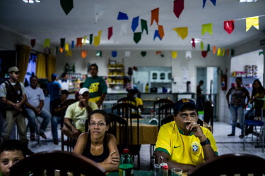 Brazil fans at a truck stop in Bahia State watch despondently as their team concedes goal after goal during the semi final of the 2014 Football World Cup against Germany. The final score was 7:1.