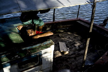 A fisherman on a boat in the port of Camamu.
