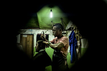 Gio cuts the hair of his friend Sando in a barbershop in Camamu, a small town in Bahia.