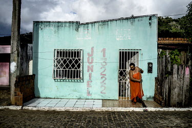 A woman sweeps outside her house in Sao Jose, a small Bahian town.