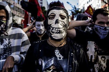Protesters wearing masks join in a demonstration ahead of the Germany vs Argentina final of the 2014 Football World Cup at the Maracana stadium in Rio.