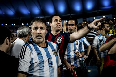 Argentina fans looking disappointed file out of the Maracana stadium after their team was beaten 1:0 by Germany in the final of the 2014 Football World Cup in Brazil.