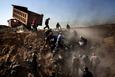 Villagers scavenge for discarded, low-grade coal being dumped near the Datong Coal Mine Group's (Tong Mei) Mei Yukou coal mine.