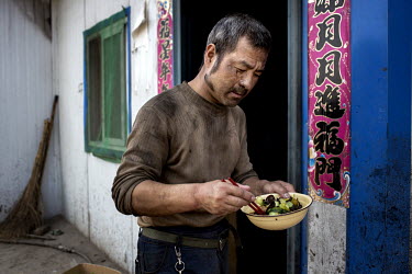 A coal miner eats his lunch at the Datong Coal Mine Group's (Tong Mei) Tong Xiu coal mine.