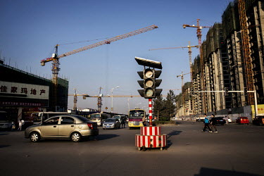 Traffic passes a construction site in New Ping Wang, a housing complex built for people working for the Datong Coal Mine Group's (Tong Mei) Mei Yukou coal mine.