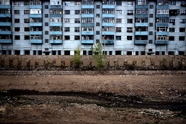 A dried up river bed in front of a dilapidated residential complex housing workers, and their dependants, of the Datong Coal Mine Group's (Tong Mei) Yong Ding Zhuang coal mine. According to Greenpeace...