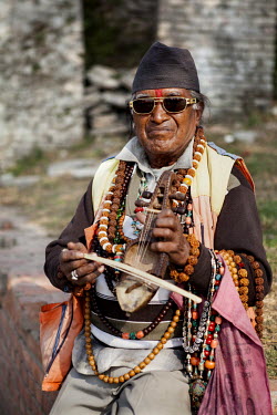 A man is selling a musical instruments inside the Pashupati temple.
