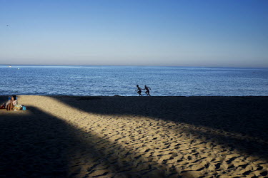Boys run and play on the beach in Torreblanca (Fuengirola). The long broad beach, stretching from Fuengirola, is crowded with tourists during the day throughout the summer months but in the mornings a...
