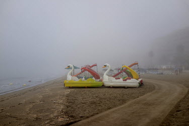 Novelty boats on the beach are enveloped by morning at Torreblanca. The long broad beach, stretching from Fuengirola, is crowded with tourists during the day throughout the summer months but in the mo...