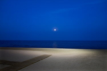 The moon shines on the beach between Fuengirola and Torreblanca. The long broad beach, stretching from Fuengirola, is crowded with tourists during the day throughout the summer months but in the morni...