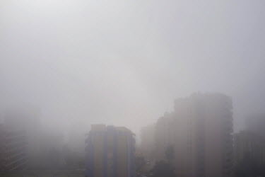 Morning fog obscures the tower blocks in Torreblanca. The long broad beach, stretching from Fuengirola, is crowded with tourists during the day throughout the summer months but in the mornings and lat...