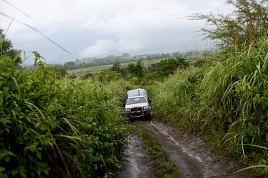 A MSF (Doctors Without Borders) vehicle drives an unpaved road near the border between Sierra Leone and Guinea. An Ebola virus epidemic of unprecedented proportions has broken out in West Africa killi...