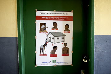 A poster from the health ministry explaining the symptoms of Ebola virus infection, on the wall of field hospital in Gueckedou. An Ebola virus epidemic of unprecedented proportions has broken out in W...