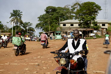 People travel by motorbike through the centre of Gueckedou, the main town near the border of Liberia. An Ebola virus epidemic of unprecedented proportions has broken out in West Africa killing at leas...