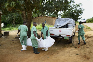 Workers from the Red Cross arrive in the village of Koundony with the body of Marie Conde (14) who died that morning after becoming infected with the Ebola virus. An Ebola virus epidemic of unpreceden...