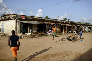Young men playing football in Gueckedou, the main town near the border of Liberia. An Ebola virus epidemic of unprecedented proportions has broken out in West Africa killing at least 539 people in thr...