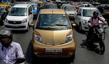 A young professional drives his new Nano Twist car in the midst of Mumbai traffic.
