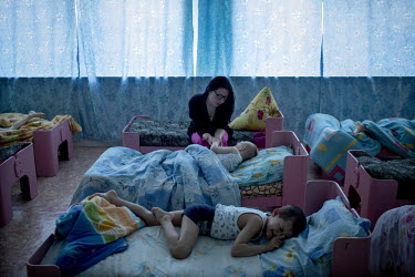 Children lie in their beds at the Solnyshko ('Little Sunshine') centre for underprivileged children in the village of Chilchi. The centre looks after orphans and children of alcoholic or ill parents....