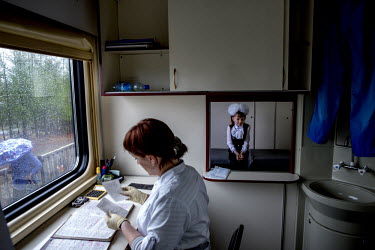 Liza Bazhanova (8) waits for the pathology results in the laboratory aboard the Matvei Mudrov train. Even at her age, she complains about the lack of decent healthcare in her home village of Olekma....