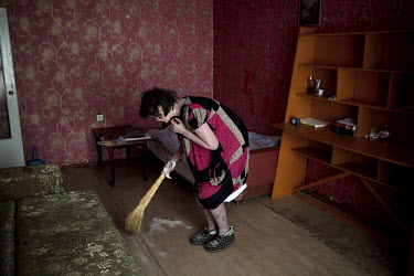 Elena Shershova, who suffers from severe psoriasis, sweeps up dead skin in her tiny apartment. She has regular appointments in Blagoveshchensk, a town some 16 hours on the train from her home. People...