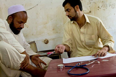 Medecins Du Monde doctors examine patients after the floods that hit the country in July 2010.