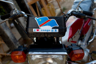 A motorbike with a French language 'I love Congo D.R.' sticker on it.