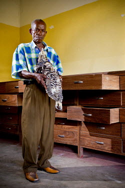 Yieni Olino, a guide in the herbarium at Yangambi research station, with a stuffed eagle. During the era of Belgian colonial rule Yangambi was the largest tropical research centre in the world and a l...