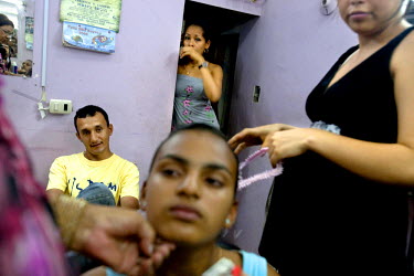 Yessina, a young girl about to turn 15, gets her hair styled for her qiunceanera (girl's 15th birthday) by her aunt Aeropajita. It is often thought that a quinceanera is a way for a girl's parents to...