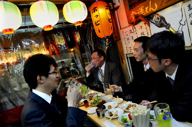 Businessmen having drinks and food after work.