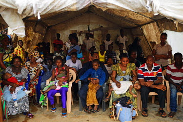 Patients wait in a tent to be screened before being accepted into the Kenema hospital in Eastern Sierra Leone on 19th August 2014. All patients and relatives who want to enter the hospital have to pas...