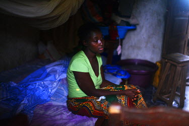 Dattu Lahai (26), an Ebola survivor,  prays inside her small house in Daru after leaving an Medecins sans Frontieres (MSF) hospital that morning.   Sierra Leone is one of three countries severely affe...